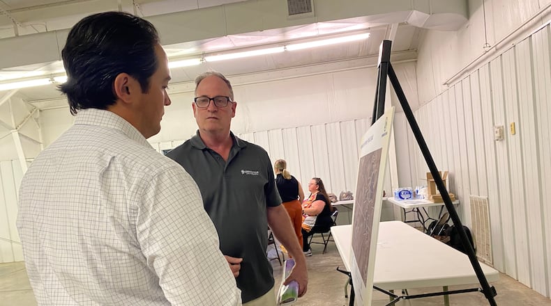 Dylan Stickney, development manager for Vesper Energy, speaks with a citizen about the proposed solar power project in Greene County on Tuesday. Eileen McClory / Staff
