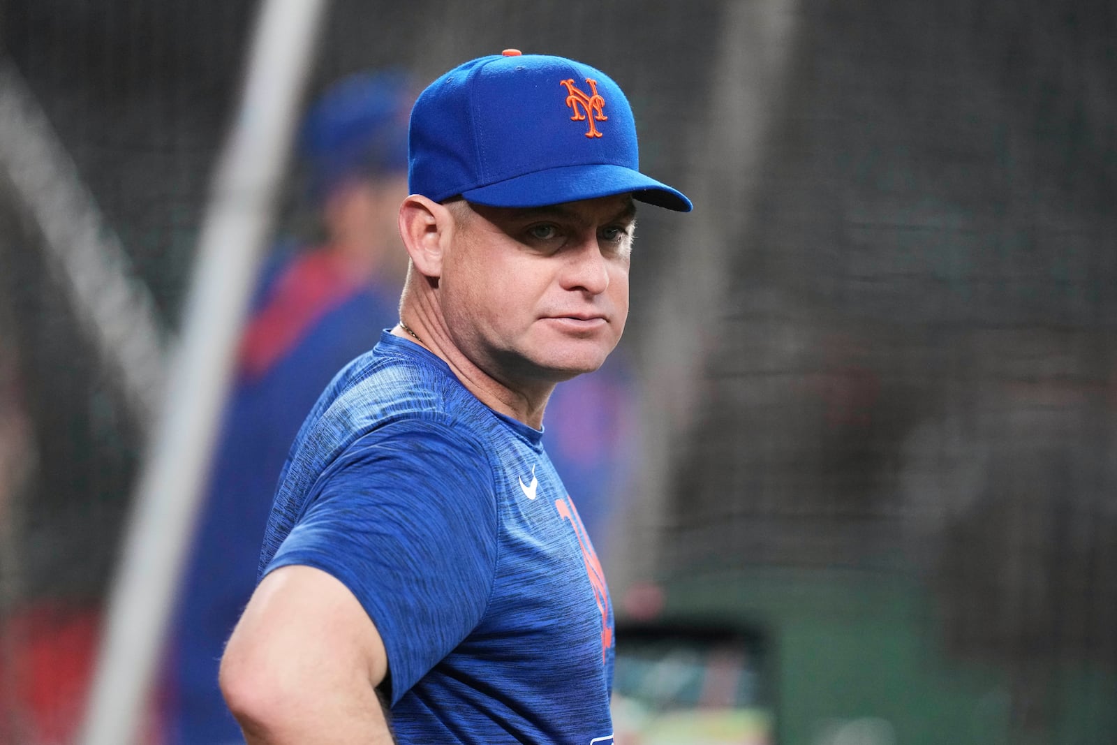 New York Mets manager Carlos Mendoza watches batting practice prior to a baseball game against the Arizona Diamondbacks Tuesday, May 6, 2025, in Phoenix. (AP Photo/Ross D. Franklin)