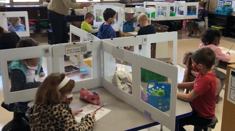 First graders work on assignments at Orchard Park Elementary school in Kettering on March 2, 2021.