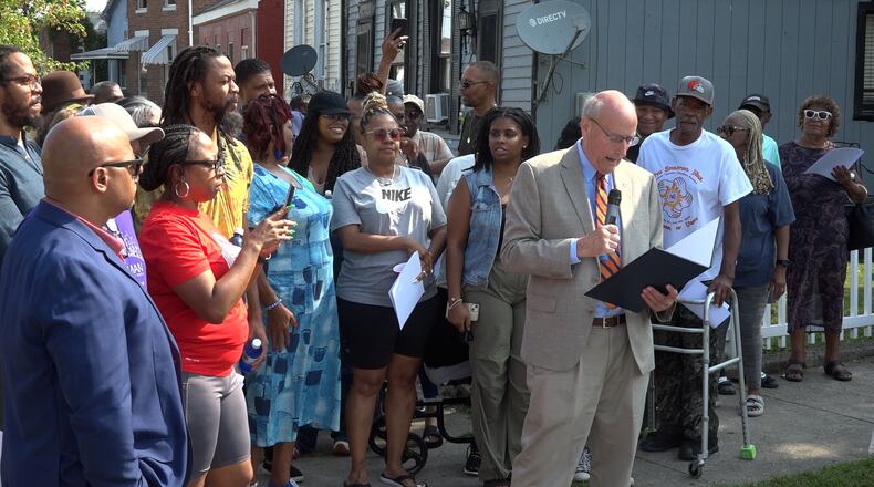 Music legend Roger Troutman, a Hamilton native, was celebrated on Tuesday morning with the honorary naming of Washington Street as Roger Troutman Street. Troutman, who died in 1999 in Dayton, grew up on Washington Street where he created his band Zapp, which included his brothers and other musicians. He famously collaborated with big names of the funk, R&B and hip-hop industry, including Snoop Dogg, Dr. Dre and Tupac Shakur. Pictured is Mayor Pat Moeller reading a proclamation at the honorary naming ceremony surrounded by Roger Troutman's family. PROVIDED/TVHAMILTON