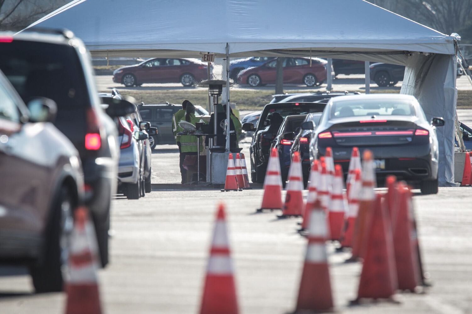 Cars line up for a coronavirus vaccine clinic at UD Arena
