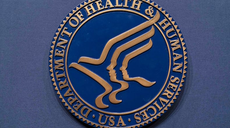 FILE = The Health and Human Services seal is seen before the news conference of Secretary Robert F. Kennedy Jr. at the Hubert Humphrey Building Auditorium in Washington, Wednesday, April 16, 2025. (AP Photo/Jose Luis Magana, File)