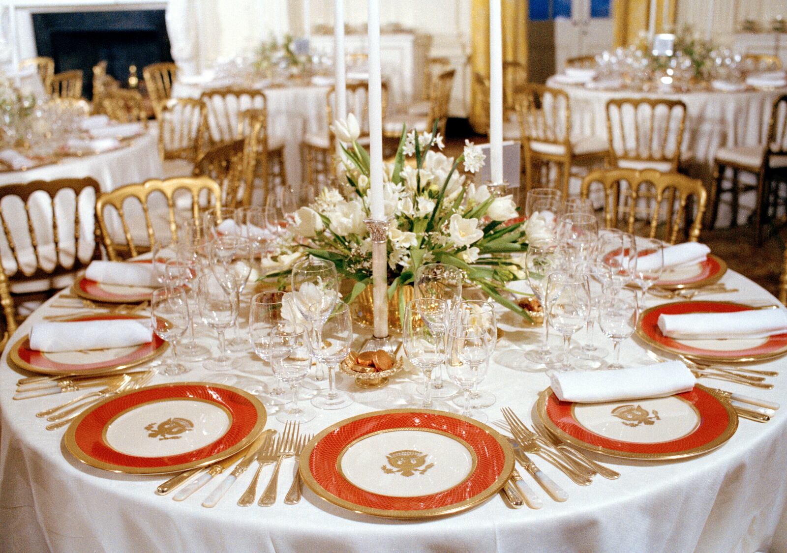 FILE - The new White House china, chosen by first lady Nancy Reagan and purchased for $209,509 through private donations, is unveiled to the press at the White House in Washington, Feb. 3, 1982. The china, as laid out for a state dinner, includes 220 place settings with 4,372 pieces. (AP Photo/Ron Edmonds, File)