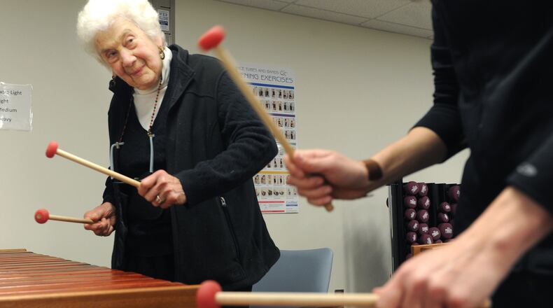 Sally Newman, 87, of Oakland plays the marimba during a new class at the University of Pittsburgh for people with mild cognitive impairment. (Nate Guidry/Pittsburgh Post-Gazette/TNS)