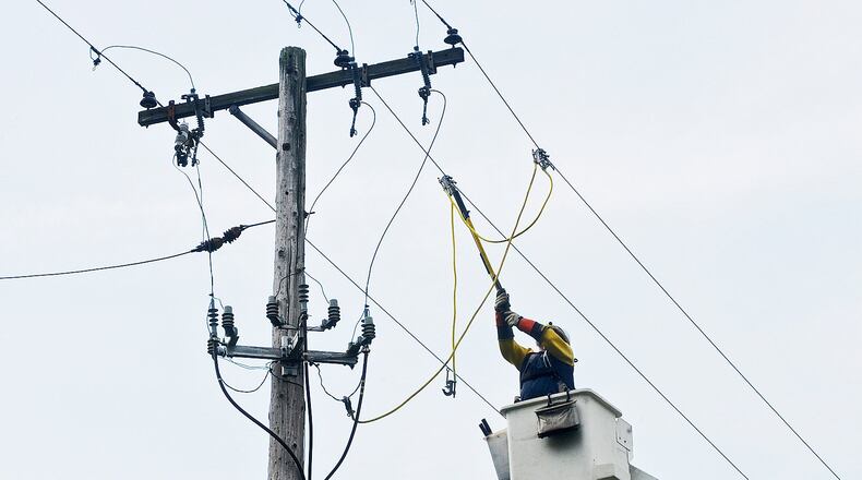 Edison Electric Institute has presented Dayton Power and Light with an award for its help in restoring power in the Southeast following Hurricane Matthew in October. In this file photo, crews from DP&L work on lines to restore power on Spinning Road in 2014. MARSHALL GORBY / STAFF