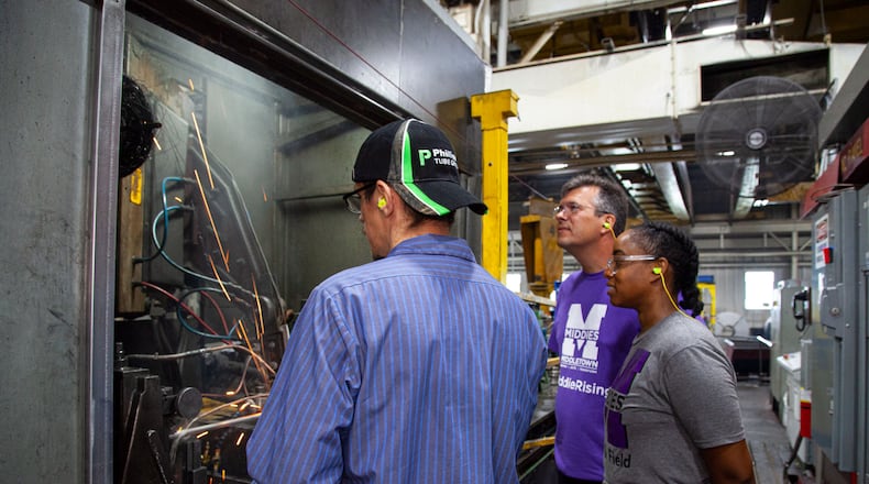 Middletown High School teachers Christa Wilson (right) and Jake Senft (middle) learn more about manufacturing steel tubing as part of a new program putting non-tech area teachers into local industries so they can better explain job and career options to their students. Butler Tech's new Manufacturing Educator Externship Team (MEET) program includes participating companies like Middletown-based Phillips Tube Group where they recently spent an eight-hour shift. (Provided Photo\Journal-News)