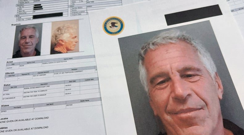 FILE - Documents that were included in the U.S. Department of Justice release of the Jeffrey Epstein files are photographed Friday, Jan. 2, 2026. (AP Photo/Jon Elswick, File)