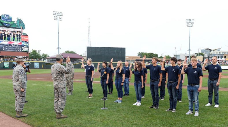 Col. Bradley McDonald, 88th Air Base Wing commander, administers the oath of enlistment at Fifth Third Field in downtown Dayton Aug. 5 to members of the delayed enlistment program as Chief Master Sgt. Kathlina Racine, 88 ABW command chief, watches. (U.S. Air Force photo/Wesley Farnsworth)