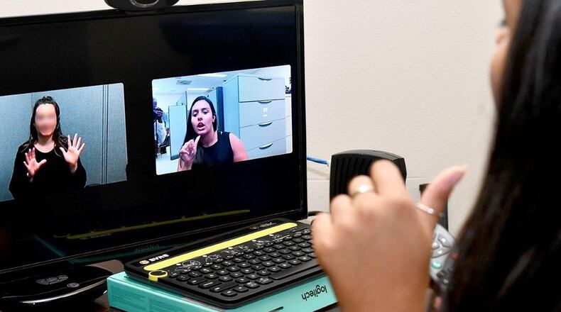 Tina Banerjee, who is deaf and a Palace Acquire intern at the 88th Air Base Wing Information Protection Office, Wright-Patterson Air Force Base, employs a video phone to communicate more effectively with Airmen across the command. (Courtesy photo)