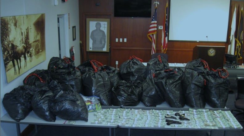 A massive drug raid in Hamilton Thursday afternoon led to the arrest of three people and the recovery of cash, weapons and more than $1 million in synthetic drugs.