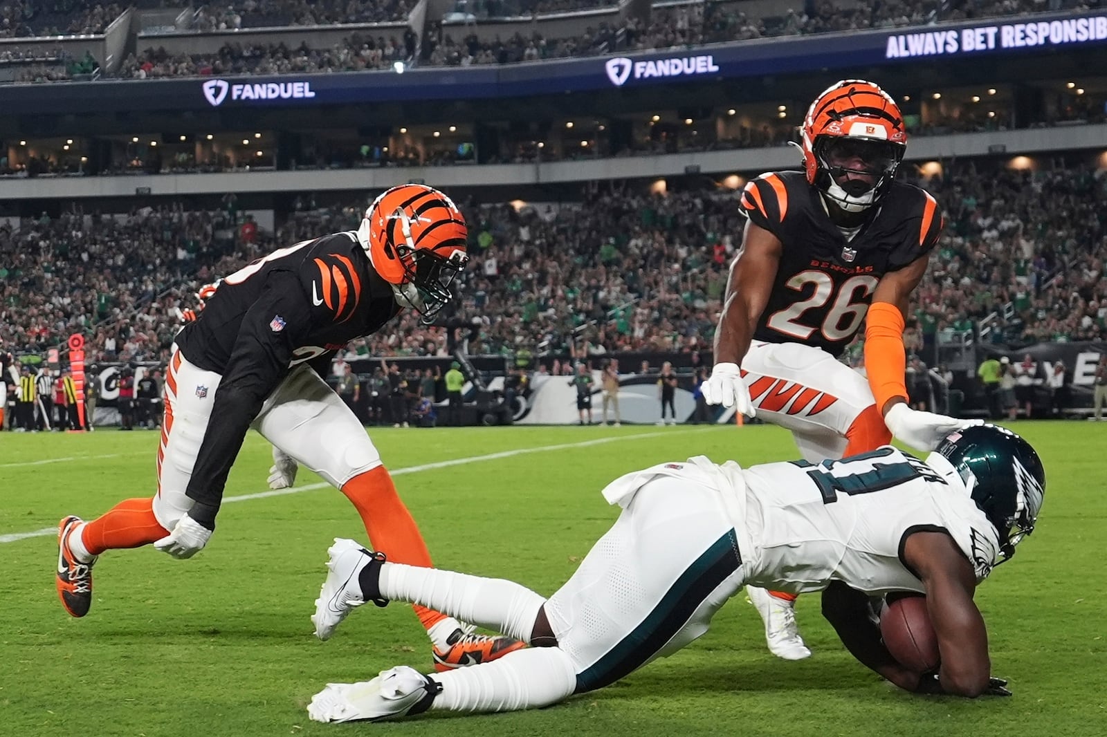 Philadelphia Eagles wide receiver Darius Cooper (41) scores a touchdown in front of Cincinnati Bengals safety Tycen Anderson (26) during the first half of an NFL preseason football game Thursday, Aug. 7, 2025, in Philadelphia. (AP Photo/Matt Slocum)