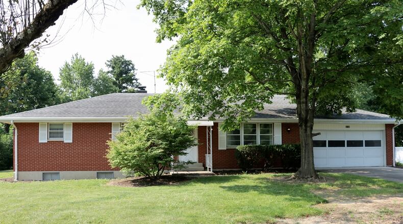 Sliding patio doors off the family room open out to a covered concrete patio. The house sits on nearly a half-acre property. The brick ranch has three bedrooms and two full bathrooms and a full, semi-finished basement. Kathy Tyler/CONTRIBUTED