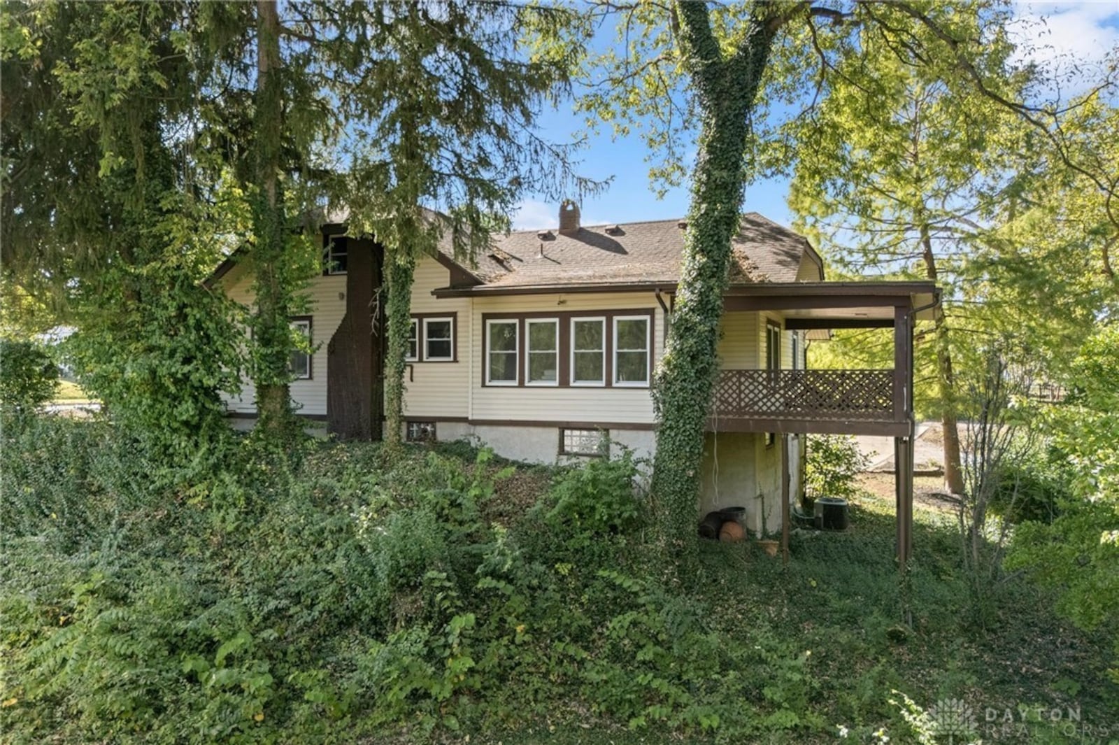 The back of the home features an elevated covered deck that opens from the main level primary suite. CONTRIBUTED
