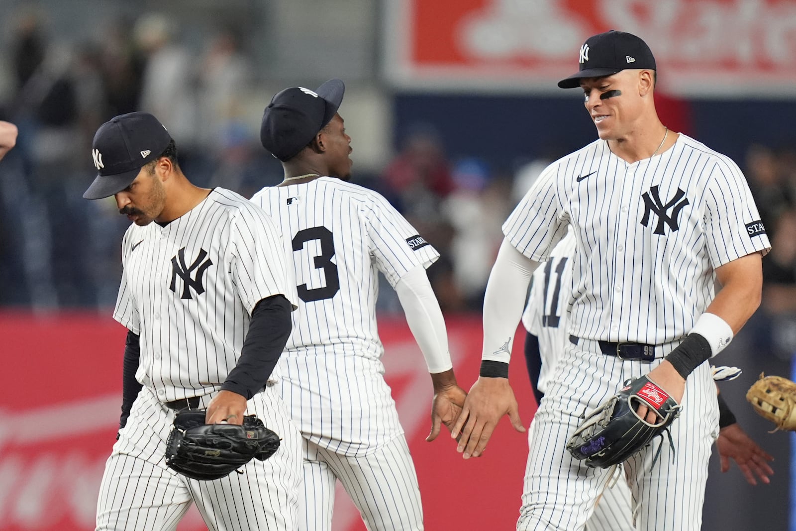 New York Yankees' Trent Grisham, left, celebrates with teammates New York Yankees' Jazz Chisholm Jr., center, and Aaron Judge after a baseball game against the Cleveland Guardians, Tuesday, June 3, 2025, in New York. (AP Photo/Frank Franklin II)