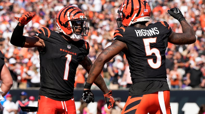 Cincinnati Bengals wide receiver Tee Higgins (5) reacts with teammate Ja'Marr Chase (1) after catching a touchdown pass against the Baltimore Ravens during the second half of an NFL football game, Sunday, Oct. 6, 2024, in Cincinnati. (AP Photo/Jeff Dean)