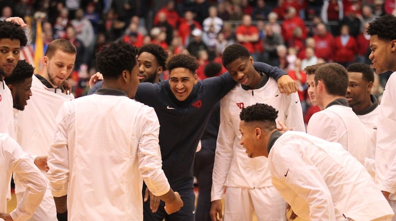Dayton players huddle before a game against Duquesne on Feb. 7 at UD Arena. David Jablonski/Staff