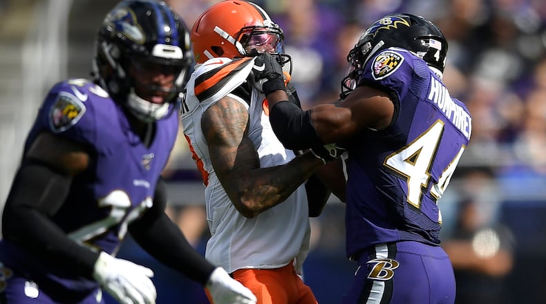 FILE - In this Sunday, Sept. 29, 2019, file photo, Cleveland Browns wide receiver Odell Beckham, center, and Baltimore Ravens cornerback Marlon Humphrey (44) grab each other during the second half of an NFL football game in Baltimore. Browns coach Freddie Kitchens wants more consistent NFL officiating after wide receiver Odell Beckham Jr. was choked during Sunday’s game. Beckham got into a skirmish with Ravens cornerback Marlon Humphrey, who pinned the three-time Pro Bowler and had his hands around his neck before being pulled away. Both players were assessed personal fouls, but neither was ejected. Kitchens said he planned to reach out to the league about that situation in particular and officiating evenness in general. (AP Photo/Nick Wass, File)