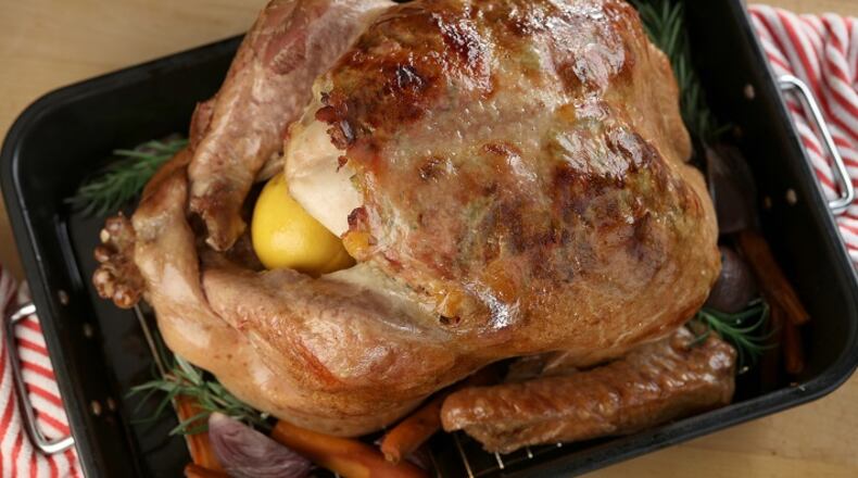 The stuffing helps crisp the skin because the pork-based stuffing bathes it in fat during roasting. (Michael Tercha/Chicago Tribune/TNS)