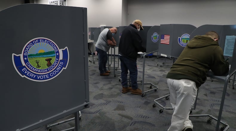 Voters at the Champaign County Government Center cast their votes. BILL LACKEY/STAFF