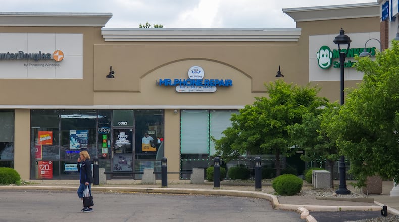 A shopper walks back to her car at Sugarcreek Shopping Plaza on Wednesday. The shopping center, which is located on Wilmington Pike, was purchased by California-based 4317 Madison LLC for $13.7 million on April 7. BRYANT BILLING / STAFF