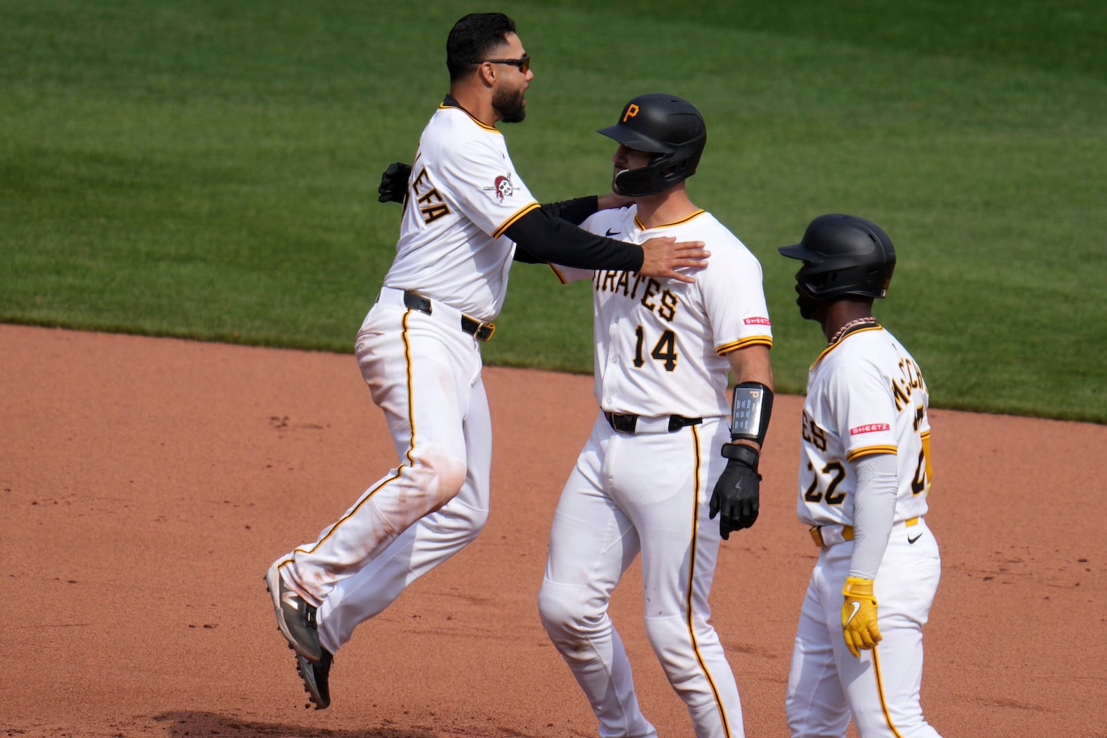 Pittsburgh Pirates' Joey Bart, center, celebrates with Andrew McCutchen, right, and Isiah Kiner-Falefa after driving in the game-winning run with a single off St. Louis Cardinals pitcher Chris Roycroft during the 13th inning of a baseball game in Pittsburgh, Wednesday, April 9, 2025. (AP Photo/Gene J. Puskar)