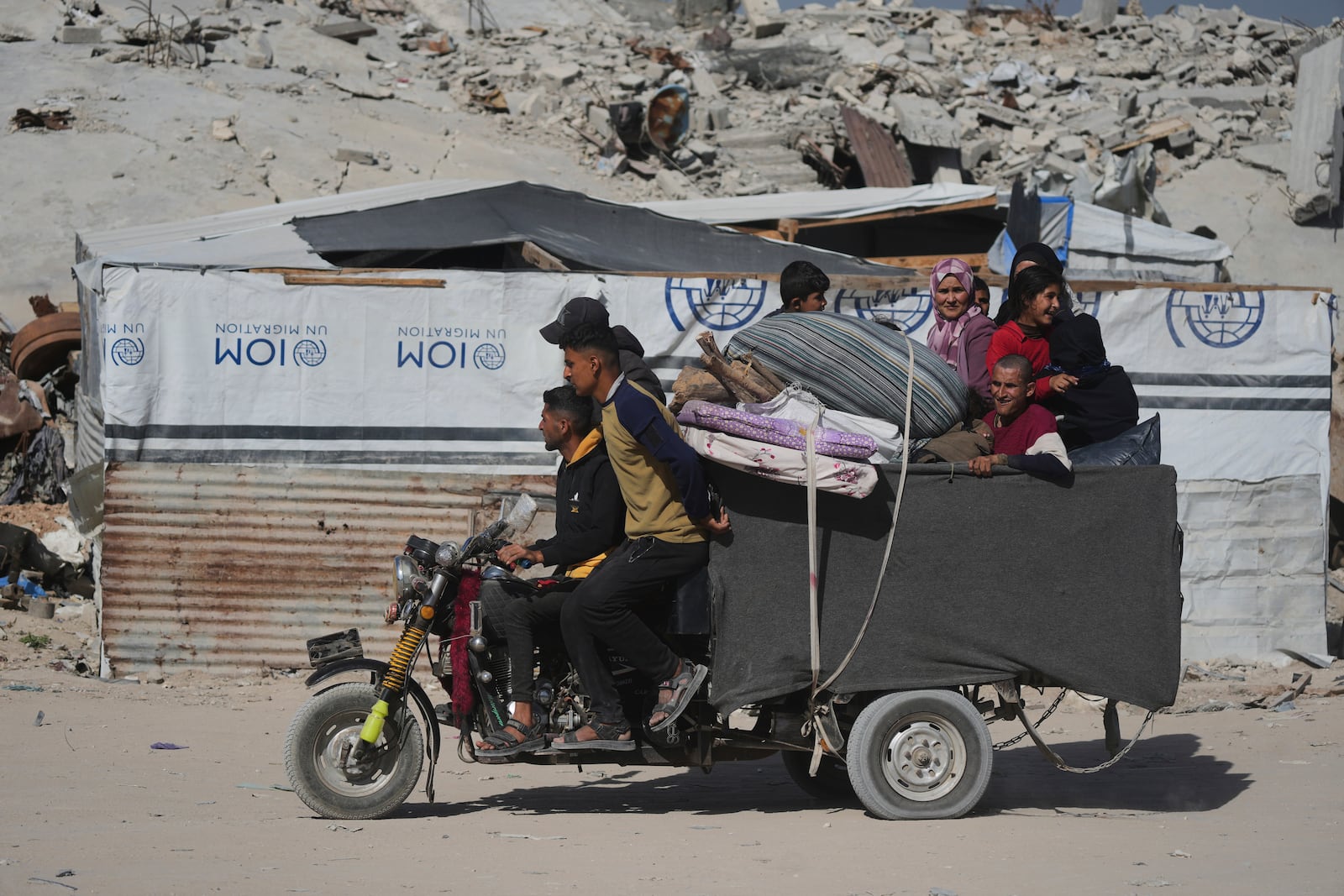 Displaced Palestinians fleeing Beit Lahia amid ongoing Israeli military operations in the Gaza Strip arrive in Jabalia, northern Gaza, on Friday, May 16, 2025. (AP Photo/Jehad Alshrafi)