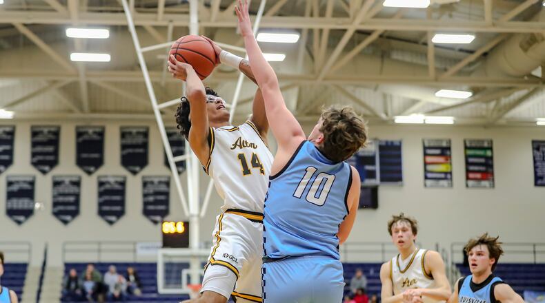 Alter High School senior RJ Greer drives to the hoop against Louisville senior Tate Ajancic during their game on Saturday night at The Beacon Orthopaedics Flyin’ to the Hoop Invitational on Saturday night at Trent Arena in Kettering. MICHAEL COOPER/CONTRIBUTED