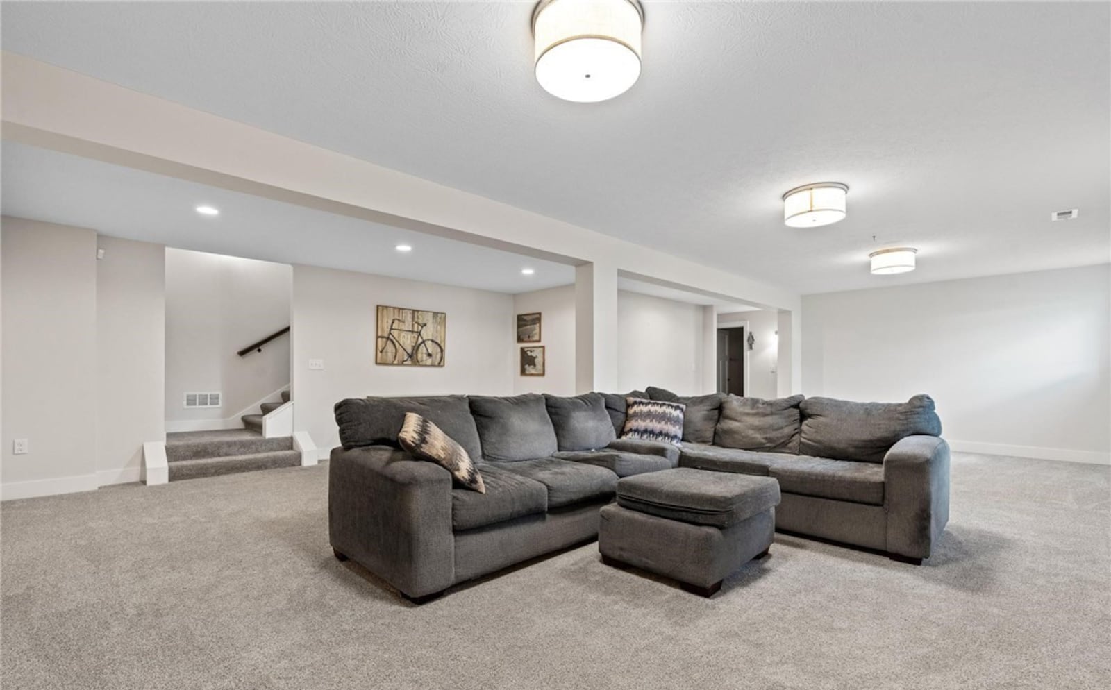 The finished basement features a recreation room with neutral carpeting and storage cabinets. There is also an additional bedroom with egress and full bathroom on this level. CONTRIBUTED