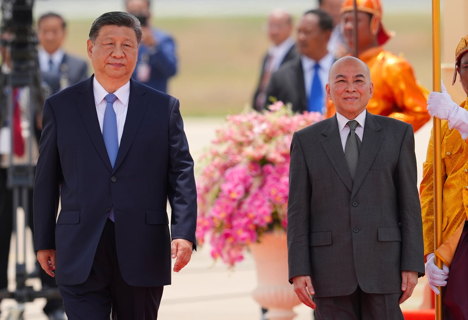 In this photo released by Agence Kampuchea Press (AKP), Cambodia's King Norodom Sihamoni, right, and Chinese President Xi Jingping attend a welcome ceremony at Phnom Penh International Airport in Phnom Penh, Cambodia, Thursday, April 17, 2025. (AKP via AP)