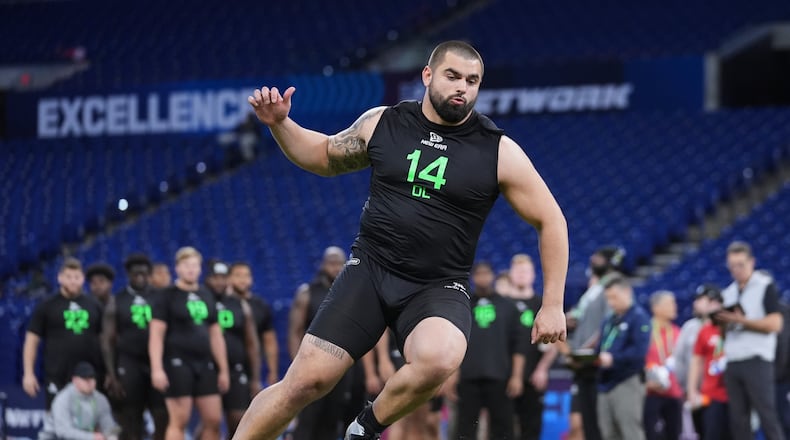 Georgia offensive lineman Dylan Fairchild runs a drill at the NFL football scouting combine in Indianapolis, Sunday, March 2, 2025. (AP Photo/Michael Conroy)