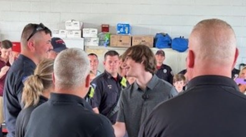 In January, Aiden Williamson, 16, a junior at Warren County Career Center, suffered a cardiac arrest while in school. He credits several medical personnel for saving his life. On Friday, Aiden presented Challenge Coins during a ceremony at Clearcreek Twp. Fire Station 21. RICK McCRABB/CONTRIBUTED