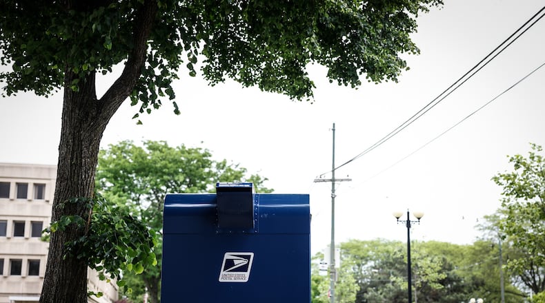 A postal box sits ready for use outside the U.S. postal service office on Fifth St. in Dayton. JIM NOELKER/STAFF