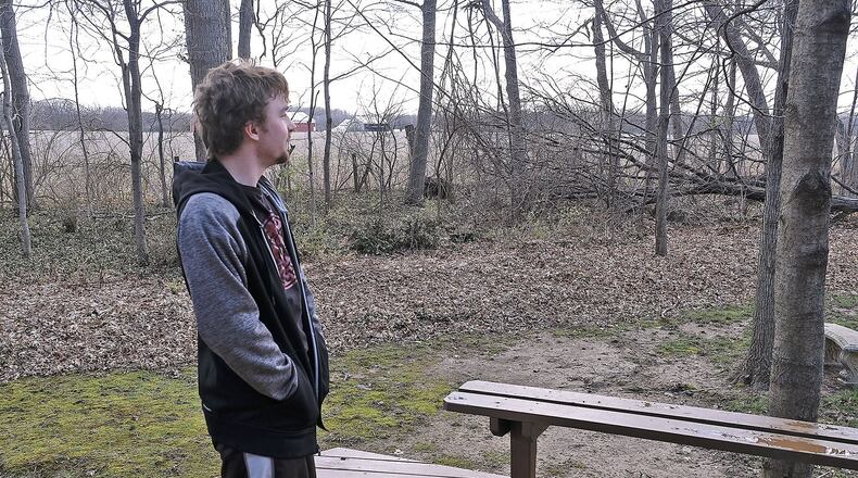 Daniel Pensworth looks out of the field located behind his house near where Enon Sand and Gravel wants to dig deeper in its limestone mine. Bill Lackey/Staff