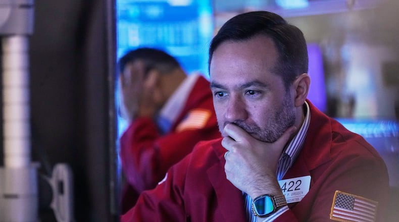 Trader Robert Greason works on the floor of the New York Stock Exchange, Friday, Nov. 14, 2025. (AP Photo/Richard Drew)
