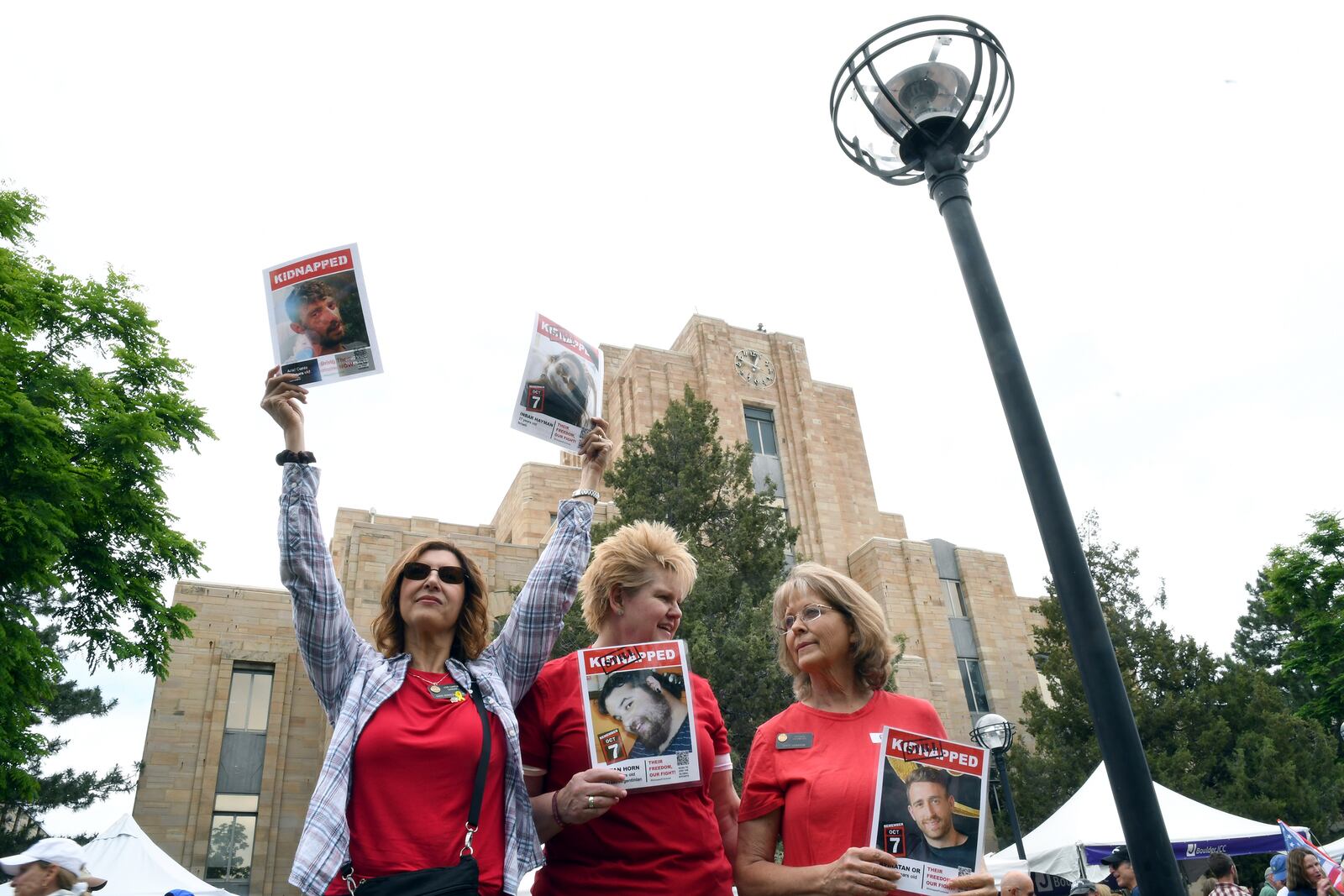 Colorado State Rep. Lori Garcia Sander, left, state GOP Chair Brita Horn, center, and state Sen. Barbara Kirkmeyer, right, show support for the hostages held in Gaza during the Boulder Jewish Festival in Boulder, Colo., on Sunday, June 8, 2025.(AP Photo/Thomas Peipert)