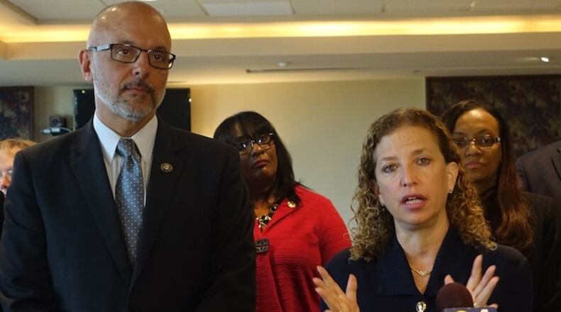 U.S. Rep. Debbie Wasserman Schultz, D-Fla., speaks as Rep. Ted Deutch looks on, Monday, June 6, 2016, at Nova Southeasten Univesity in Davie, Fla., during a round table event about the Zika virus. Florida will experience a "disaster" with the Zika virus if federal authorities don't immediately provide money to help battle the virus, Florida Gov. Rick Scott said Wednesday. (Joe Cavaretta/South Florida Sun-Sentinel via AP) MAGS OUT; MANDATORY CREDIT