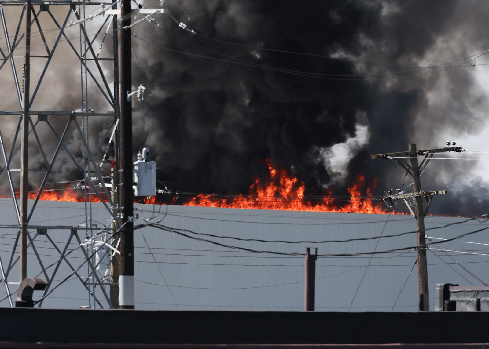 The fire at Fuyao Glass America rekindled shortly before noon on Tuesday, March 24. While firefighters have been working at the site since it first caught fire Sunday night, they had been focusing on hotspots before a large rekindling caused black smoke to rise that was visible for miles. The building that caught fire was Fuyao's coating facility, which was still in the finishing stages of construction. BRYANT BILLING / STAFF