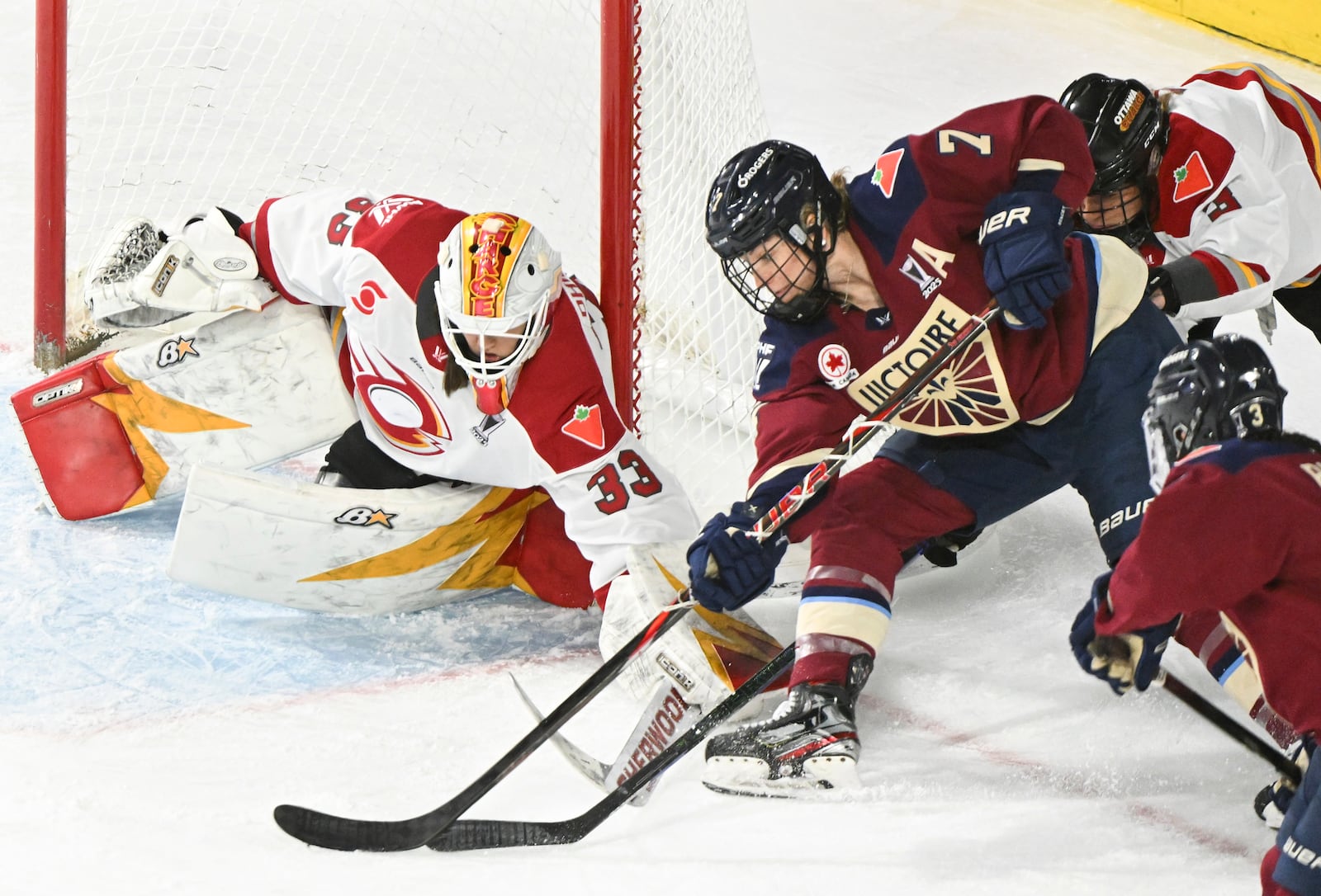 Montreal Victoire's Laura Stacey (7) tries a wraparound against Ottawa Charge goaltender Gwyneth Philips (33) during third overtime period PWHL hockey playoff action in Laval, Quebec, Sunday, May 11, 2025. (Graham Hughes/The Canadian Press via AP)