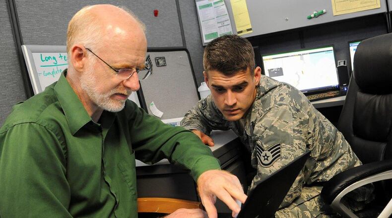 Staff Sgt. Joshua Modlin, assistant noncommissioned officer in charge of the 88th Security Forces Squadron’s Electronic Security Systems, works with Joe Andrews of M.C. Dean Inc. to establish a configuration baseline by ensuring the more than 16,000 ESS assets throughout Wright-Patterson Air Force Base are accurately identified Sept. 20. Andrews helped develop the Infrastructure Maintenance Management System being implemented throughout the Air Force to not only track maintenance of critical ESS infrastructure, but also help to identify trending problems and develop improvements that can be implemented enterprise wide. (U.S. Air Force photo/Jim Varhegyi)