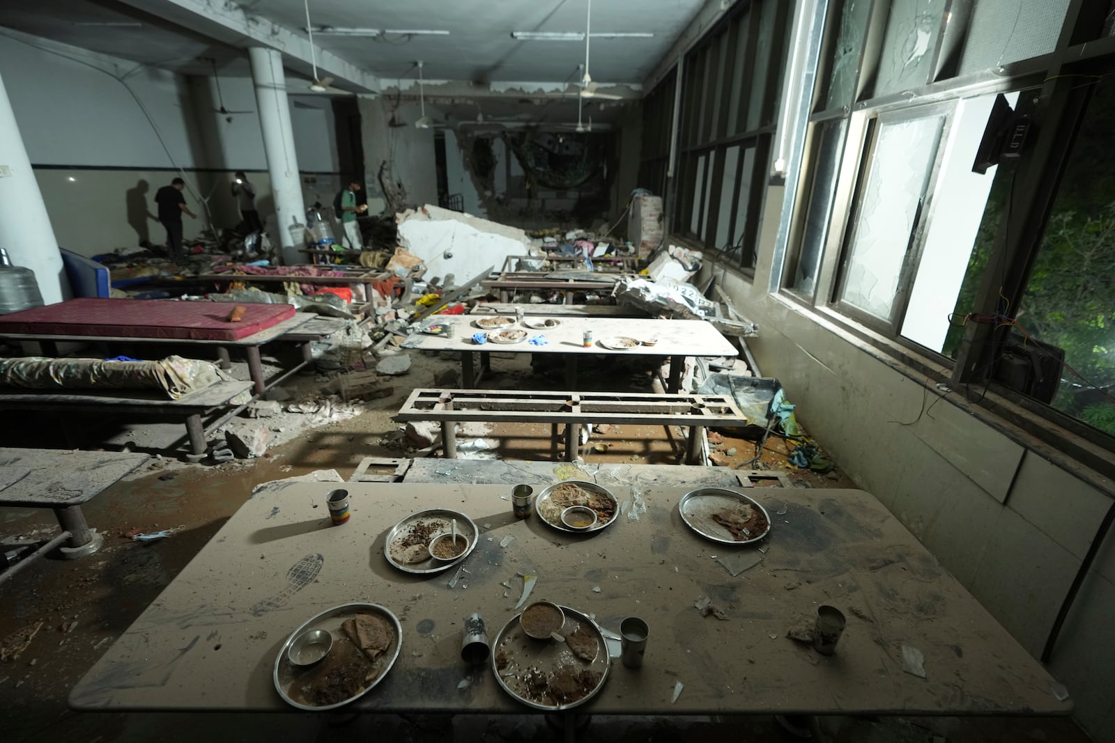 Inside view of a canteen building where the tail of the airplane stuck at the site of an airplane that crashed in India's northwestern city of Ahmedabad in Gujarat state, India, Thursday, June 12, 2025. (AP Photo/Ajit Solanki)