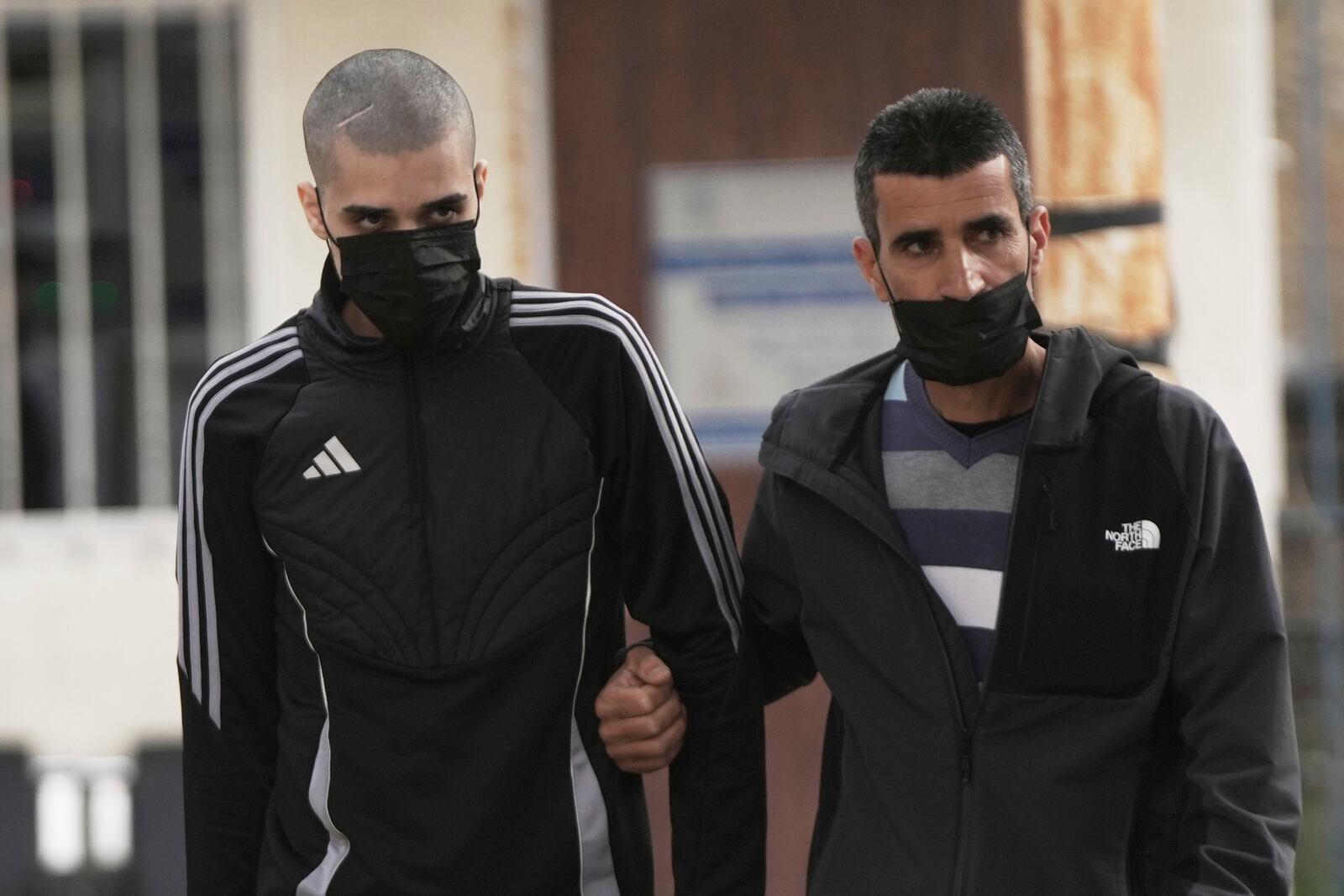 Palestinian Ahmed Manasra, left, who took part in an attack in 2015 when he was 13 and developed schizophrenia in prison, walks upon his release in Jerusalem, Thursday, April 10, 2025. (AP Photo/Mahmoud Illean)