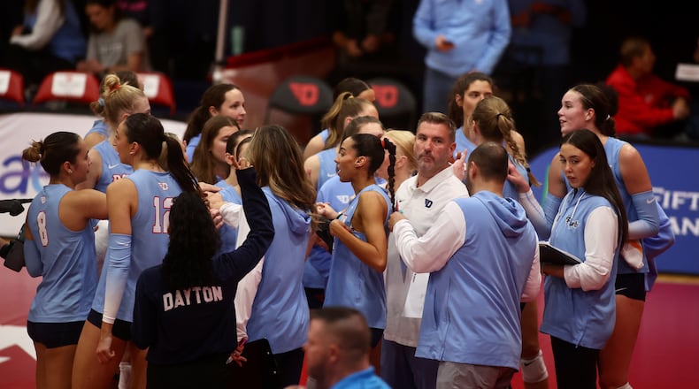 Dayton huddles during a match against Davidson on Friday, Nov. 8, 2024, at the Frericks Center in Dayton. David Jablonski/Staff