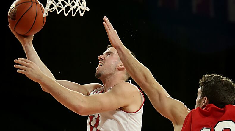 Miami forward Logan McLane scores while covered by Olivet forward R.J. Haas during their game at Millett Hall in Oxford on Thursday, Dec. 29, 2016. Contributed photo by E.L. Hubbard