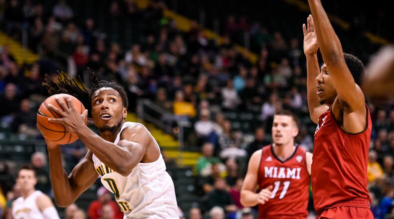 Wright State University’s Steven Davis gets ready to put up a shot under the basket defended by Miami University’s Rod Mills during the first half of their game University Tuesday, Nov. 15 at the Nutter Center at Wright State University in Fairborn. NICK GRAHAM/STAFF