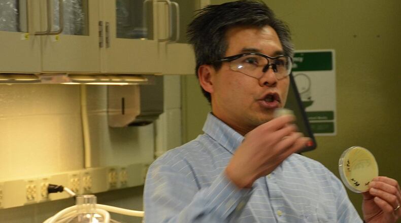Dr. Chia Hung discusses current research in the biology lab at the Air Force Research Laboratory’s Materials and Manufacturing directorate during a visit of members of the tri-service Applied Research for the Advancement of Science and Technology Priorities Program on Synthetic Biology for Military Environments. The program unites researchers from each of the service laboratories to create the organic capabilities and infrastructure within the Department of Defense for synthetic biology for future defense technology. (U.S. Air Force photo/Marisa Alia-Novobilski)