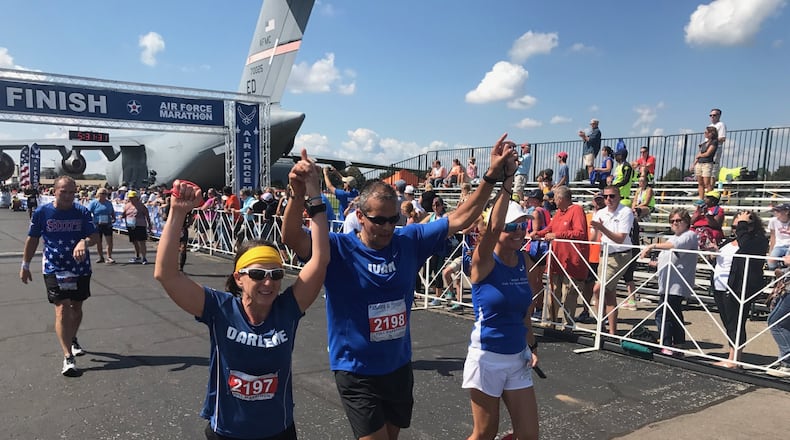 Maj. Ivan Castro (retired) finishes the 2017 Air Force Marathon. To his side are Darlene Matos on his left and Jackie Ferguson on his right while Tom Yoe follows behind. Castro, who was blinded while serving in Iraq in 2006, is the only blind Special Forces officer in U.S. Army history. Tom Archdeacon/contributed