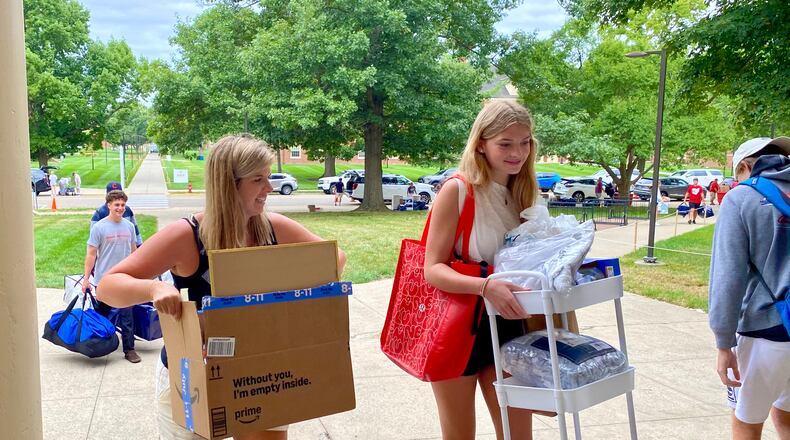 Thousands of students and their families flooded Miami University’s main campus Friday as part of the annual migration marking the new school year. The Oxford campus of Butler County’s largest university was abuzz with excitement as 4,000 incoming freshmen – most joined by their parents and helping siblings – unpacked family cars bearing license plates from around Ohio and from across the nation as part of the school’s annual move-in day. (Photo by Michael D. Clark/Journal-News)