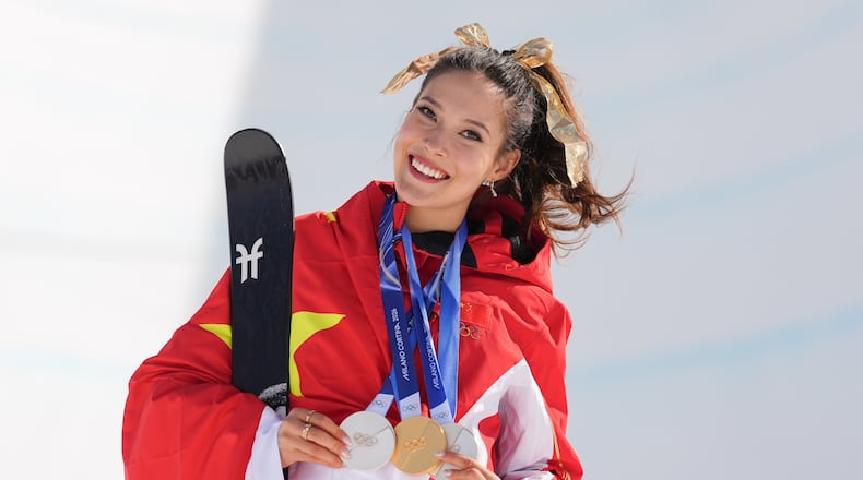 Gold medalist China's Eileen Gu poses with her medals after winning the women's freestyle skiing halfpipe final at the 2026 Winter Olympics, in Livigno, Italy, Sunday, Feb. 22, 2026. (AP Photo/Abbie Parr)