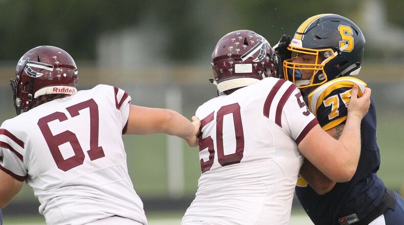 Springfield’s Isaiah Gibson, right, tries to get by Lebanon’s Luke Lane on Friday, Sept. 21, 2018, at Evans Stadium in Springfield. David Jablonski/Staff