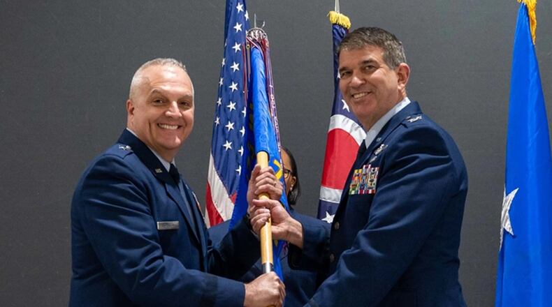 U.S. Air Force Col. Dominic Fago passes the guidon to Brig. Gen. David Johnson during a change of command ceremony on Springfield-Beckley Air National Guard Base, Ohio, April 2, 2023. Fago was the commander of the 178th Wing for over a year. (U.S. Air National Guard photo by Senior Airman Constantine Bambakidis)